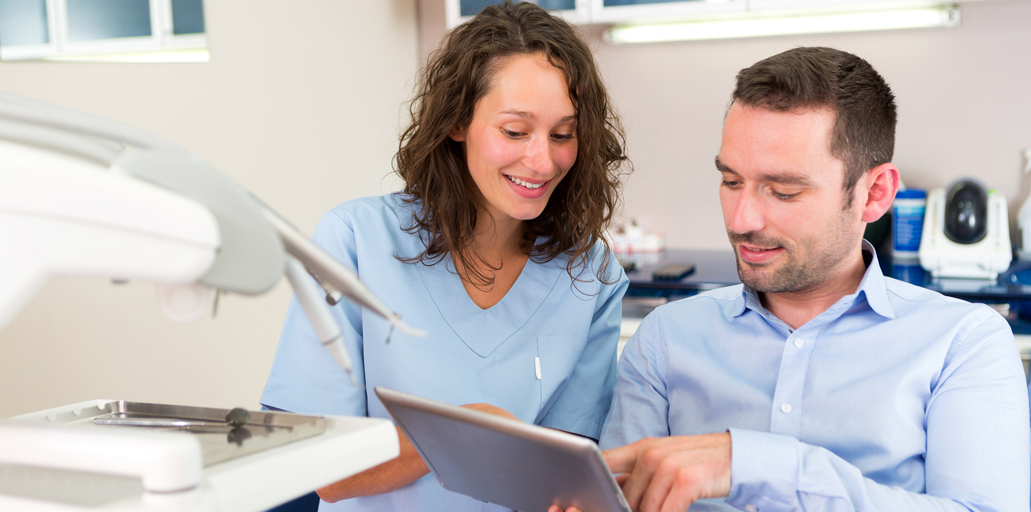 Bartlett dentist showing a patient a tablet screen