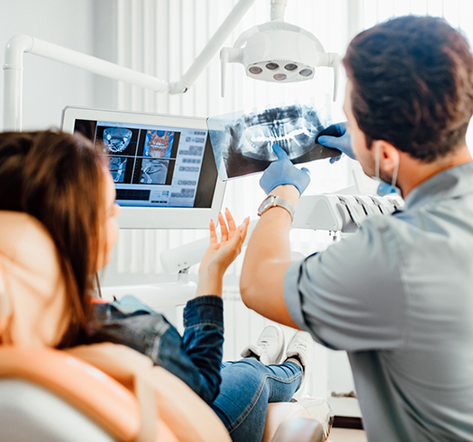 Dentist showing a patient an x ray of their teeth