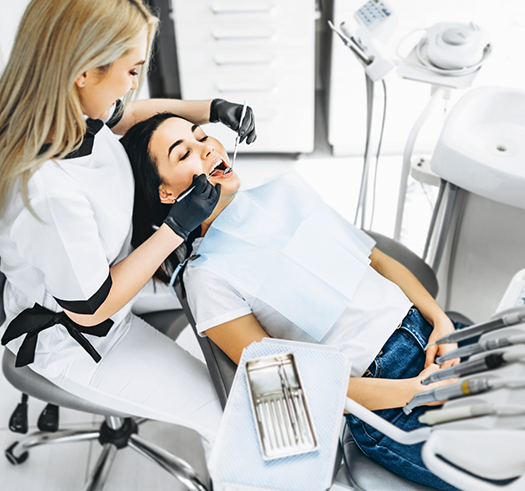 Woman having her teeth examined by her dentist