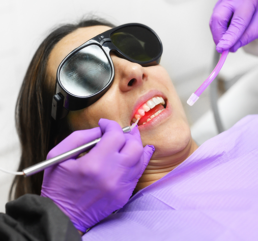 Dental patient having her gums treated with a soft tissue laser