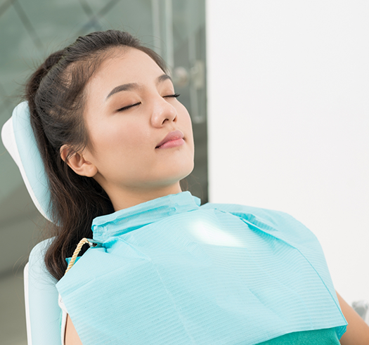 Young woman relaxing in the dental chair with her eyes closed