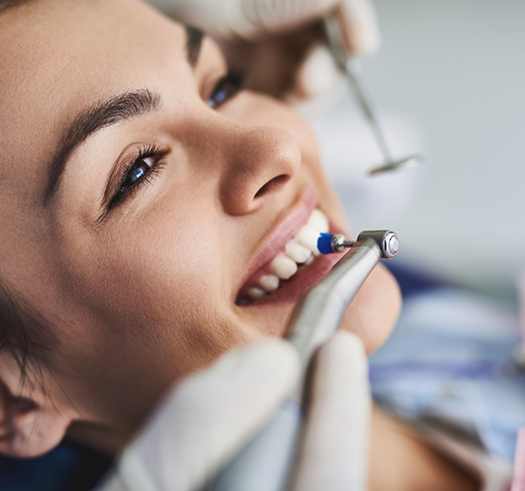 Woman in the dental chair getting a professional teeth cleaning