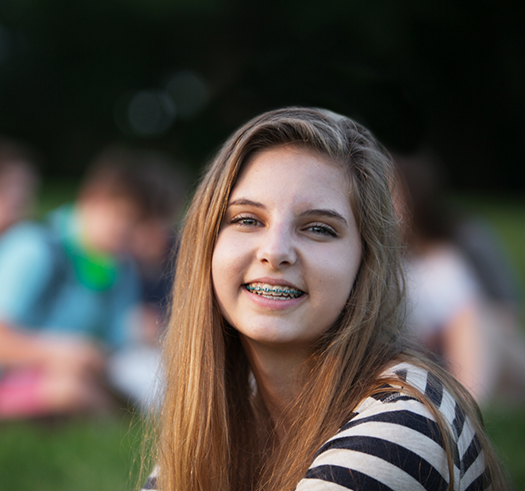 Teenage girl smiling with traditional braces