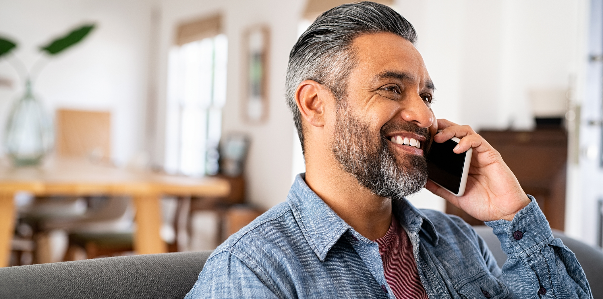 Man talking on the phone to request a dental appointment in Bartlett