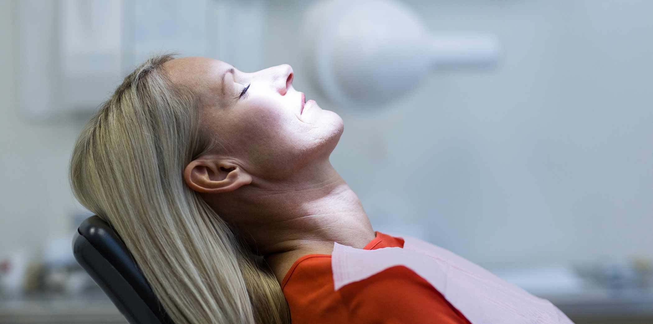 Woman relaxing in the dental chair thanks to sedation dentistry in Bartlett