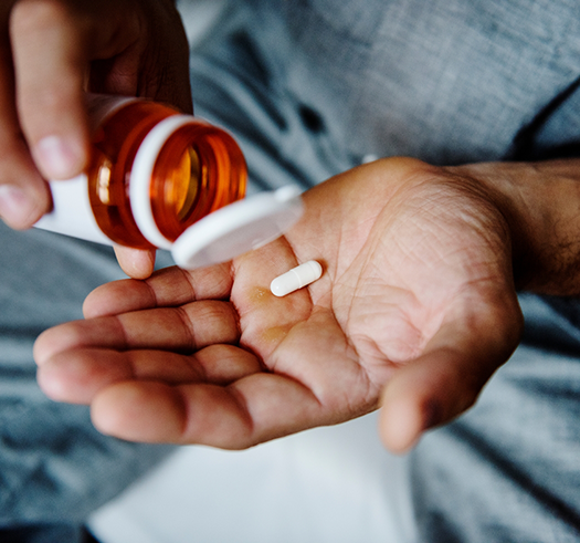 Person taking a white pill