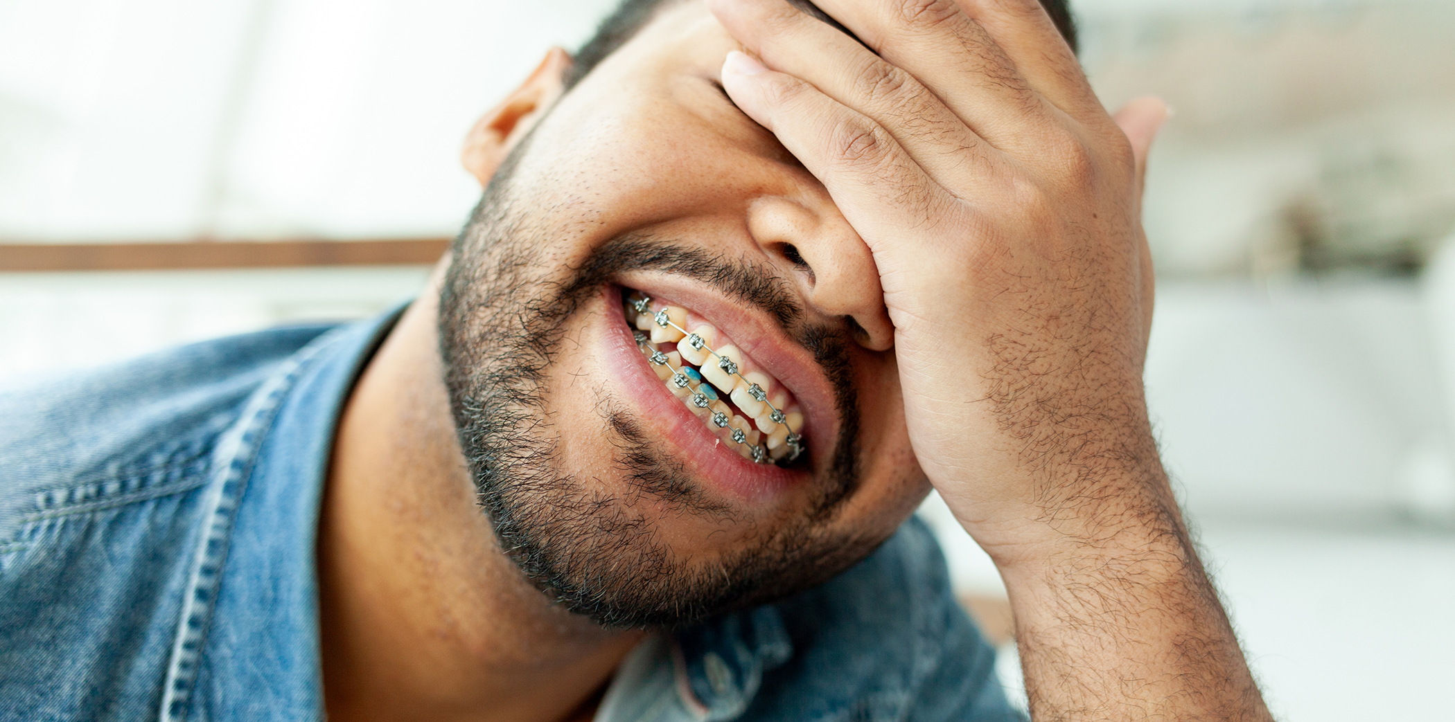 Man smiling with traditional braces in Bartlett