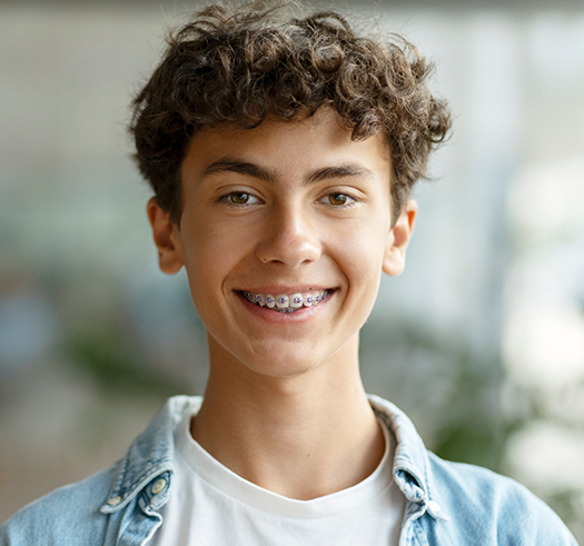 Teenage boy with traditional braces smiling